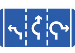 Signs showing exit directions at a roundabout